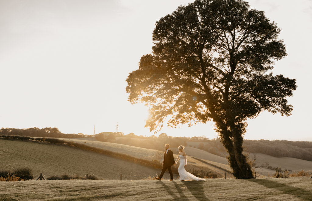 A married couple after their wedding at golden hour at a wedding venue in Surrey called Botley Hill Barn