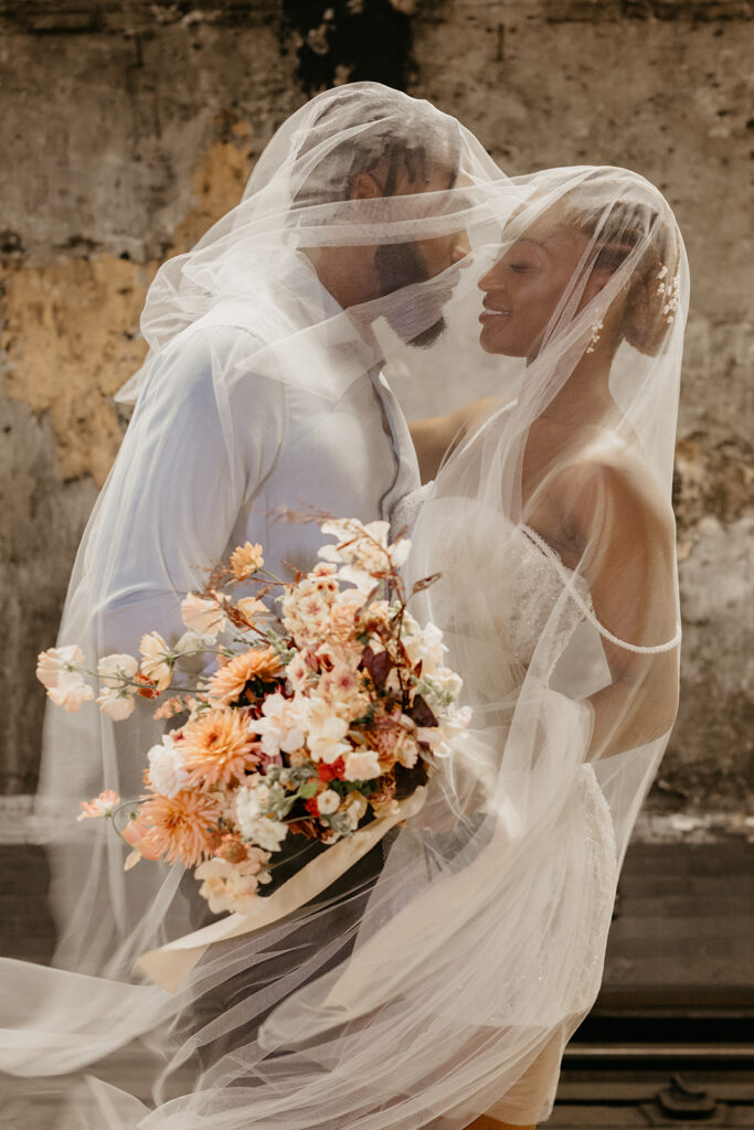 Romantic wedding veil couple portrait