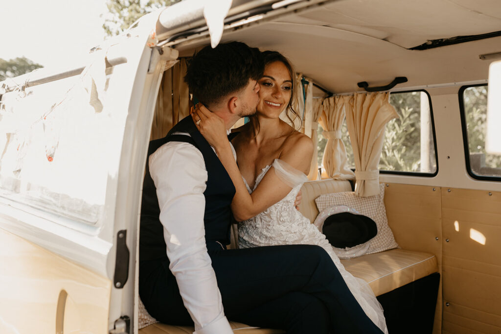 A bride and groom in a campervan photobooth