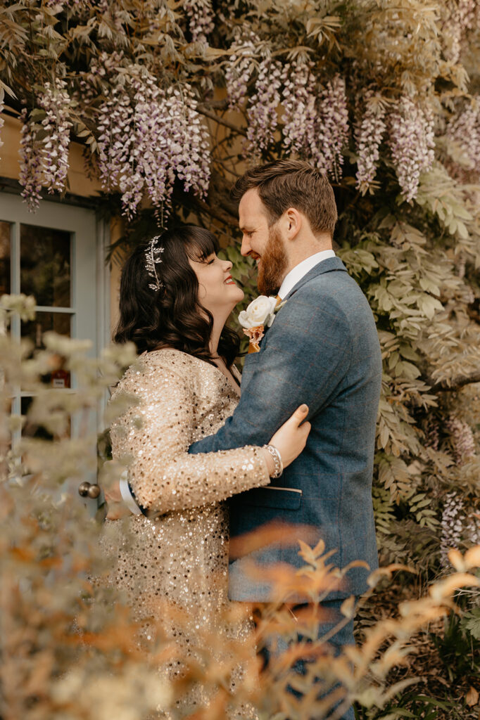 Wedding couple portraits with wisteria at South Farm Barn
