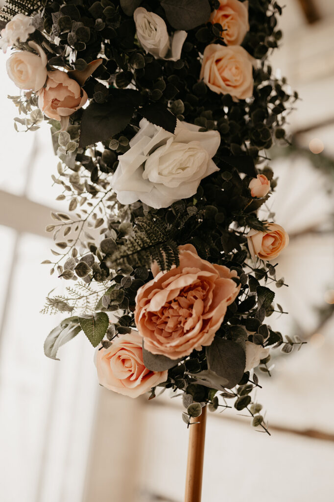 Pink and white floral arch at Lillibrooke Manor wedding venue