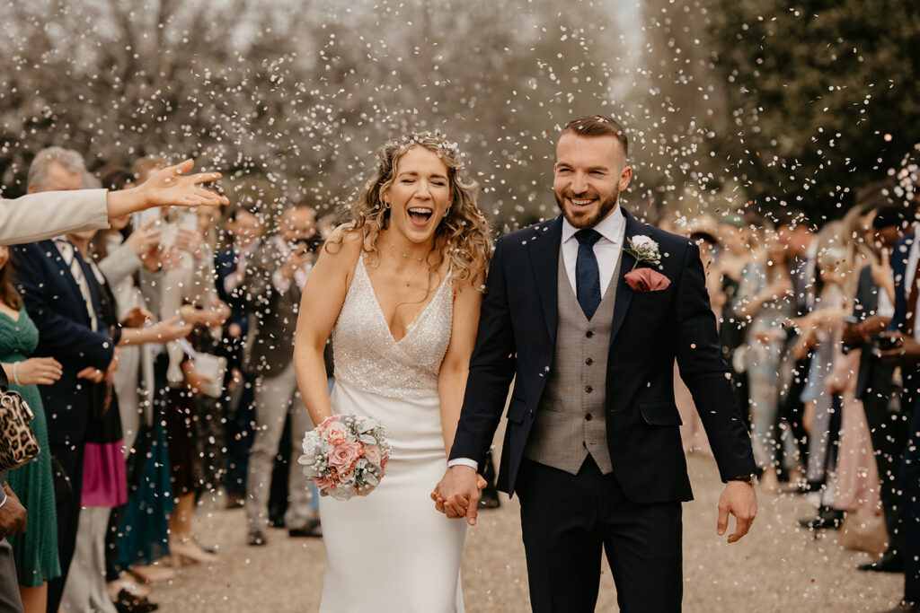 Relaxed wedding photography confetti moment at Lillibrooke Manor