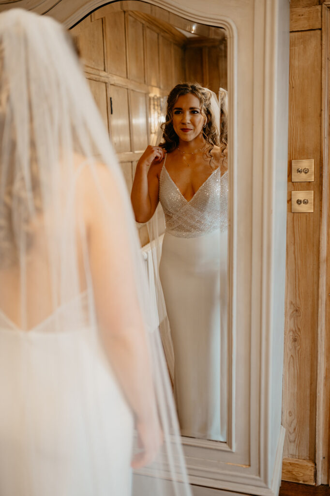 Lillibrooke Manor bride wearing a sparkly wedding dress and long veil