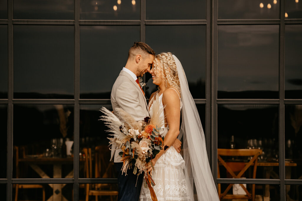Botley Hill Barn wedding couple portraits in front of the glass windows