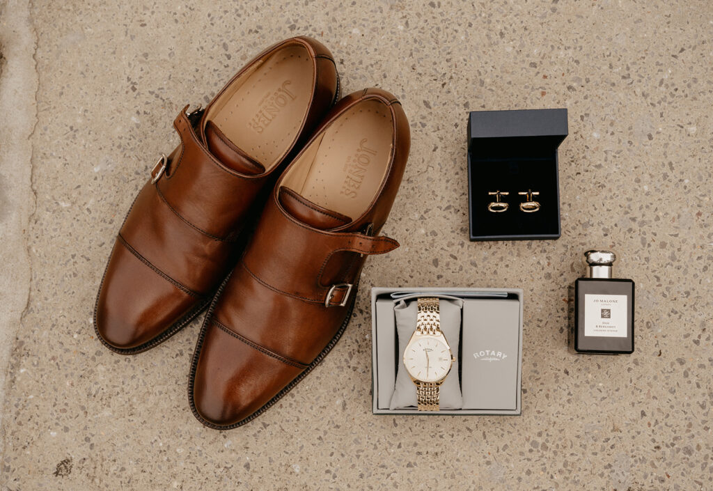 Groom details with brown shoes, a watch and cufflinks