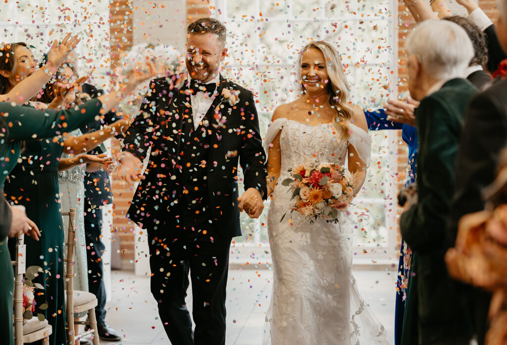 Colourful confetti exit at a Great Fosters wedding