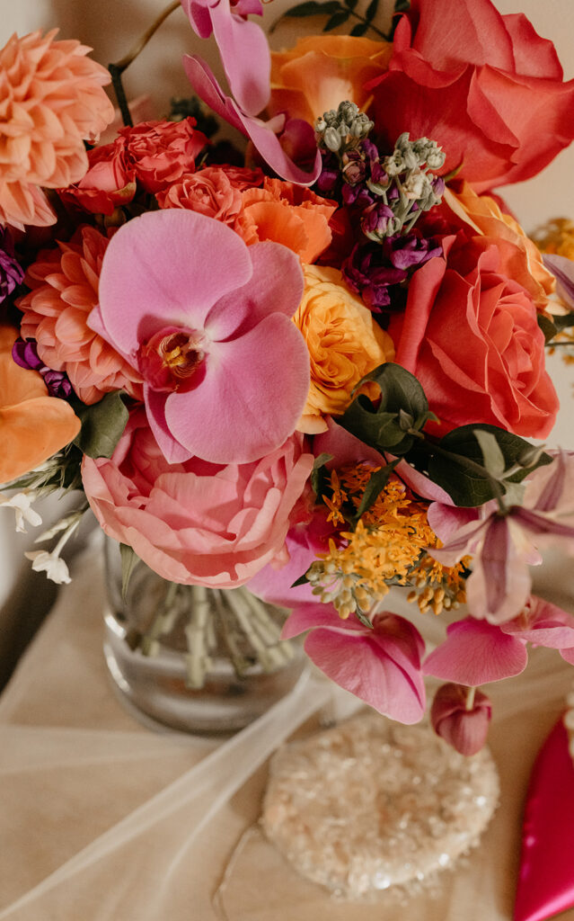Bright wedding bouquet with pink and orange orchids