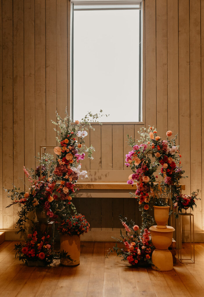 Primrose Hill Farm wedding floral arch with pink and orange flowers
